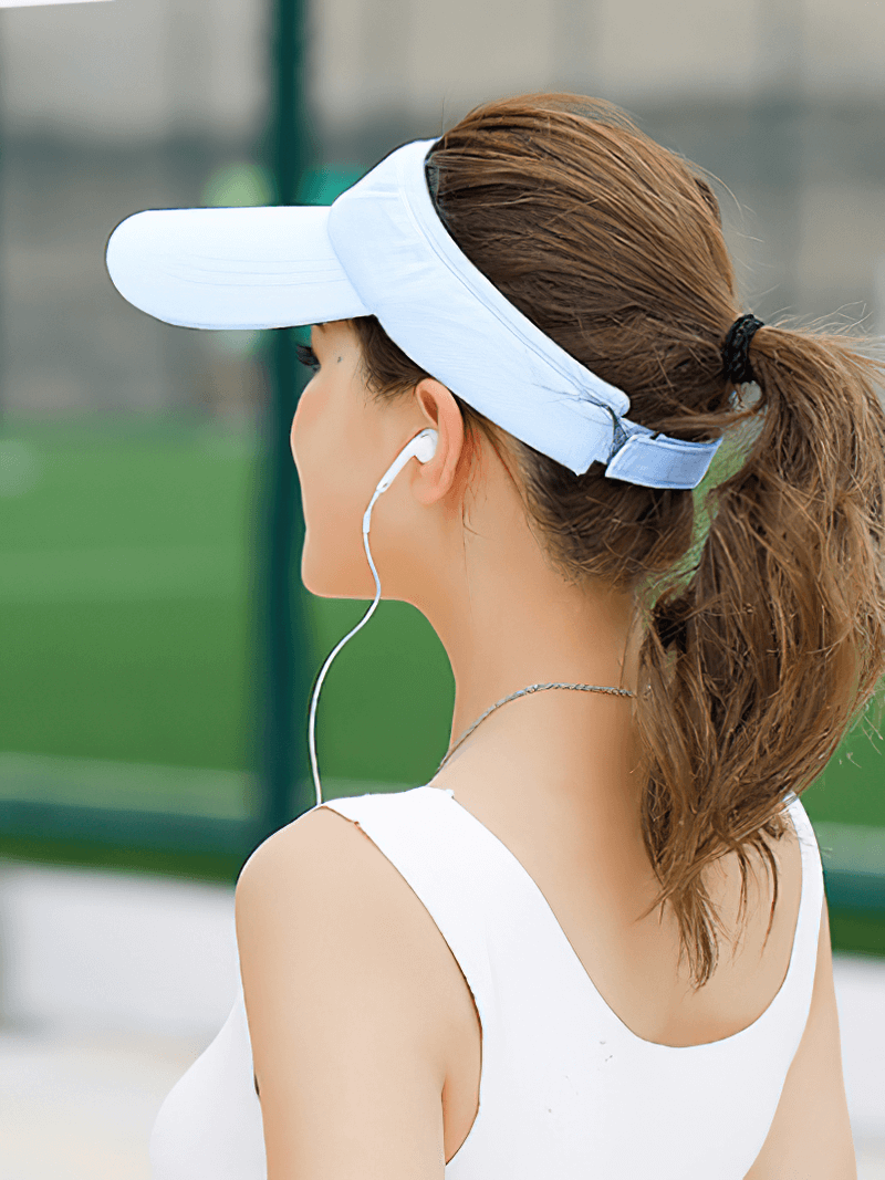 Back view of person in a blue Tennis Golf Breathable UV Protection Adjustable Visor Cap enjoying outdoor activity.